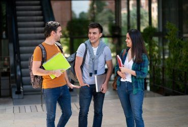 group-of-university-friends-joking-around-campus-waiting-for-class